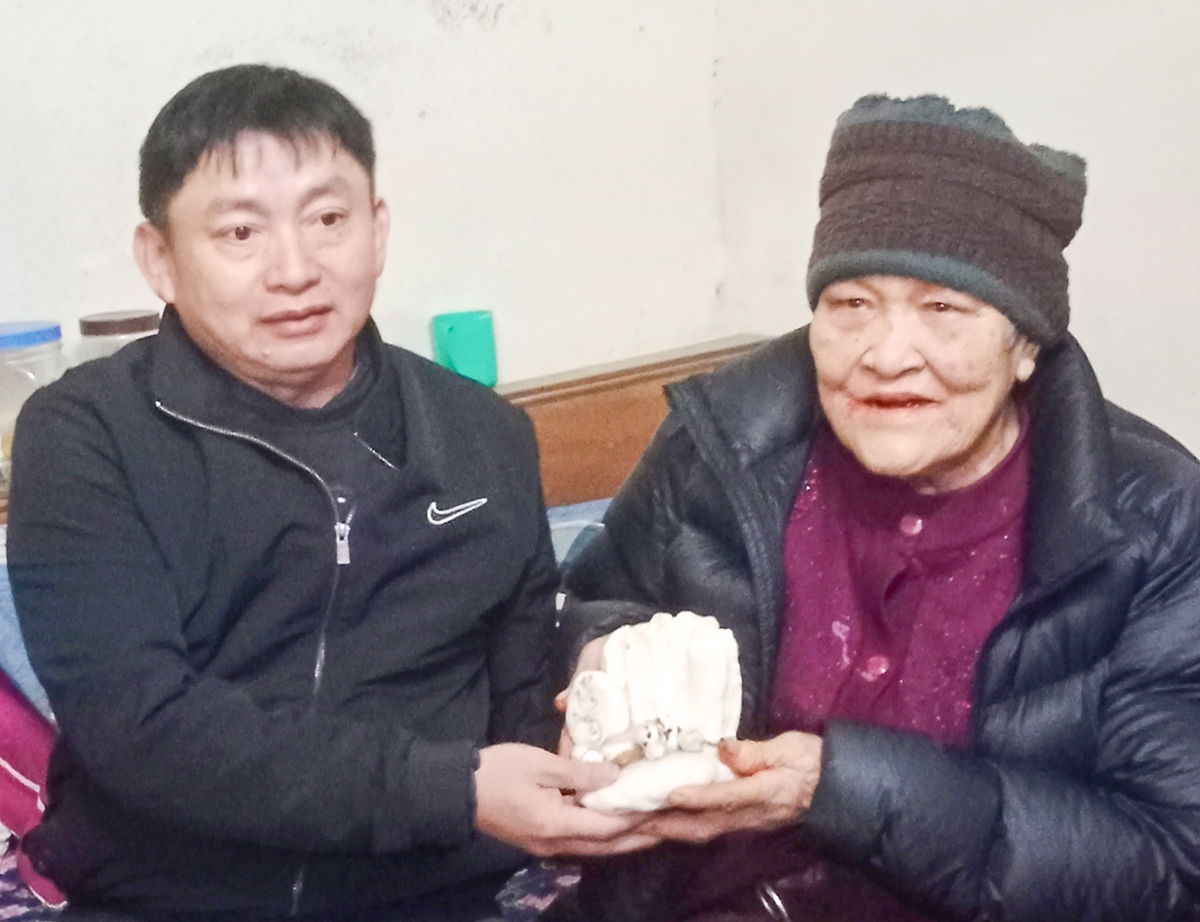 Tác giả tặng viên đá san hô từ Trường Sa cho mẹ liệt sĩ Lê Bá Giang. Ảnh: K.A